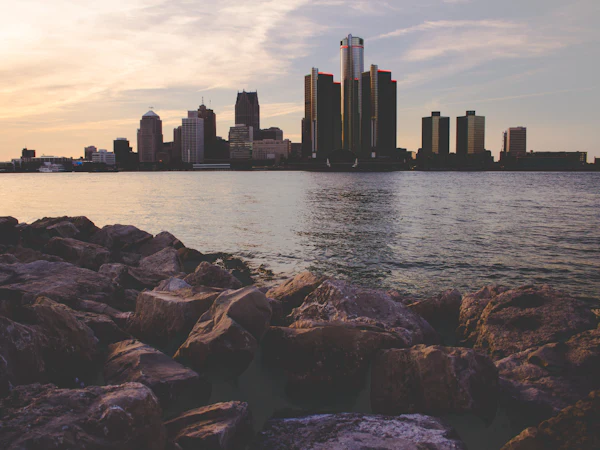 The Detroit skyline across the river, with rocks in the foreground
