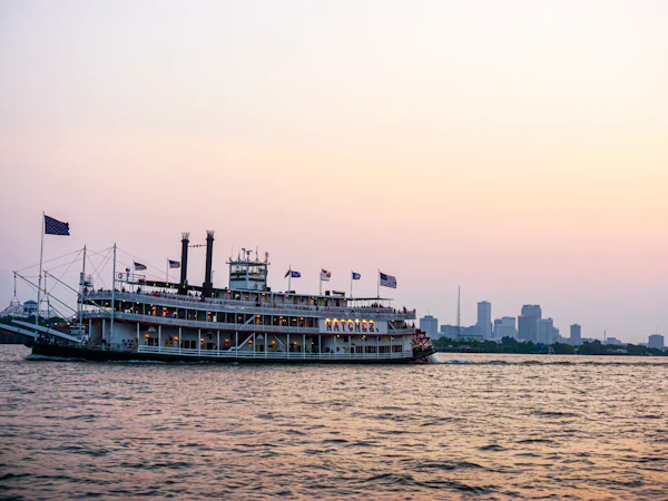 A paddle steamer on the Mississippi River at New Orleans at dusk
