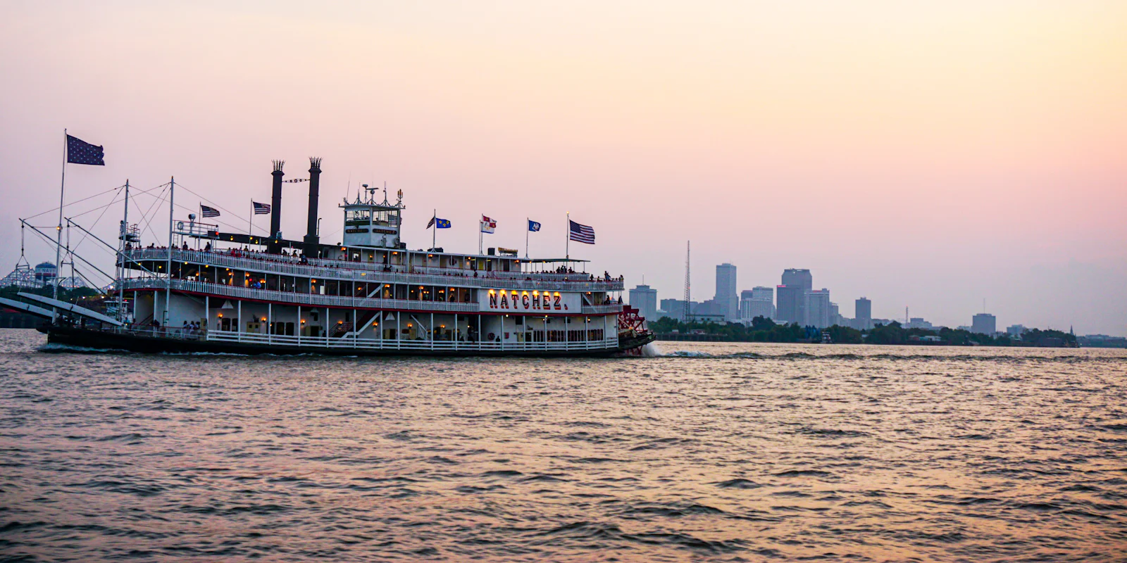 A paddle steamer on the Mississippi River at New Orleans at dusk